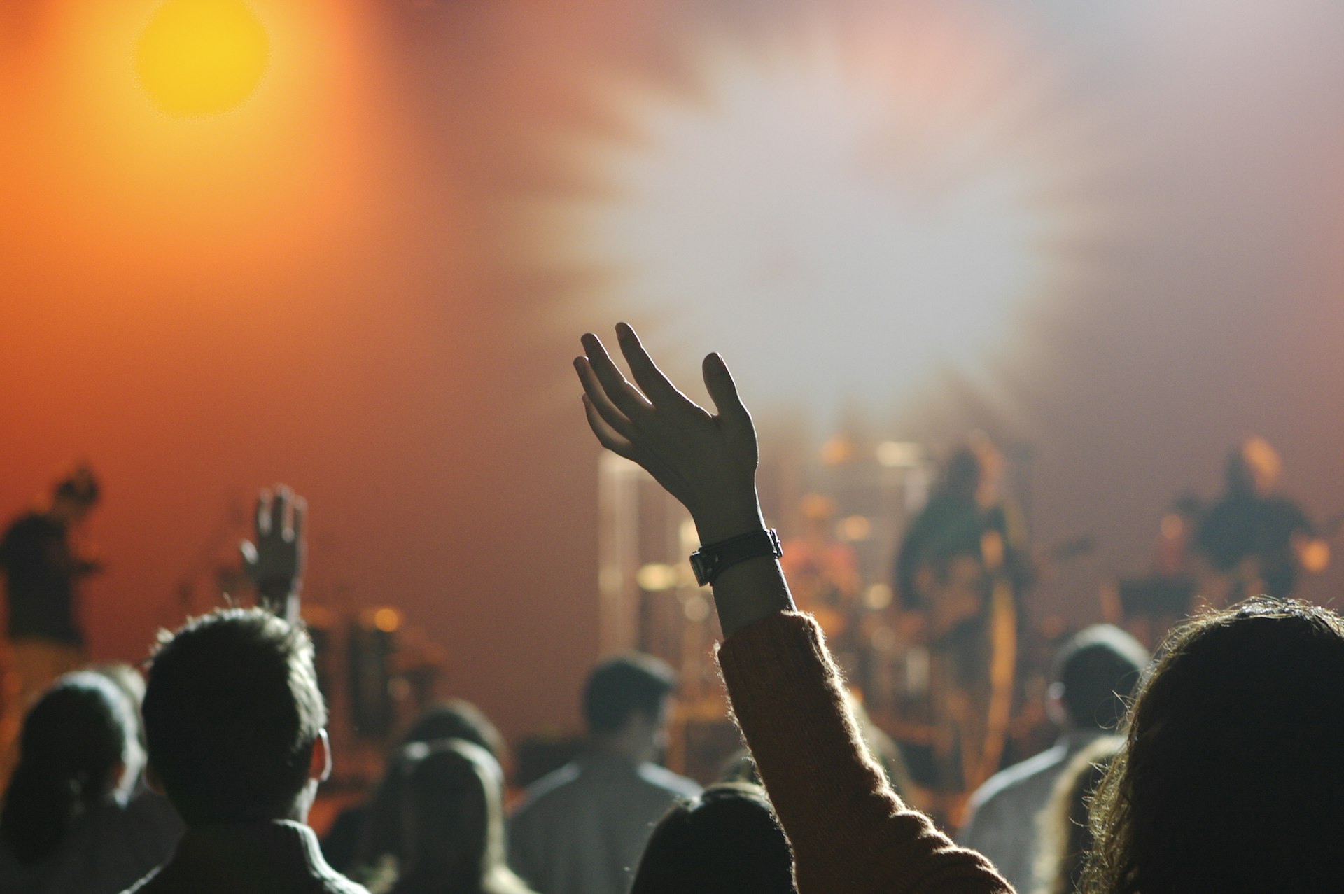 Congregation worshipping with hands raised during a live church service