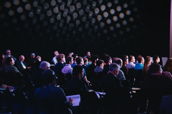 Professional conference production setup with stage lighting, audio, and live streaming for ministry events
